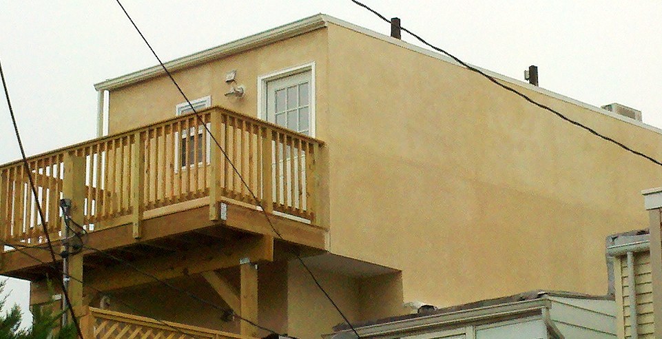 Exterior HardiPlank Siding Installed, Stone Foundation Work Commences